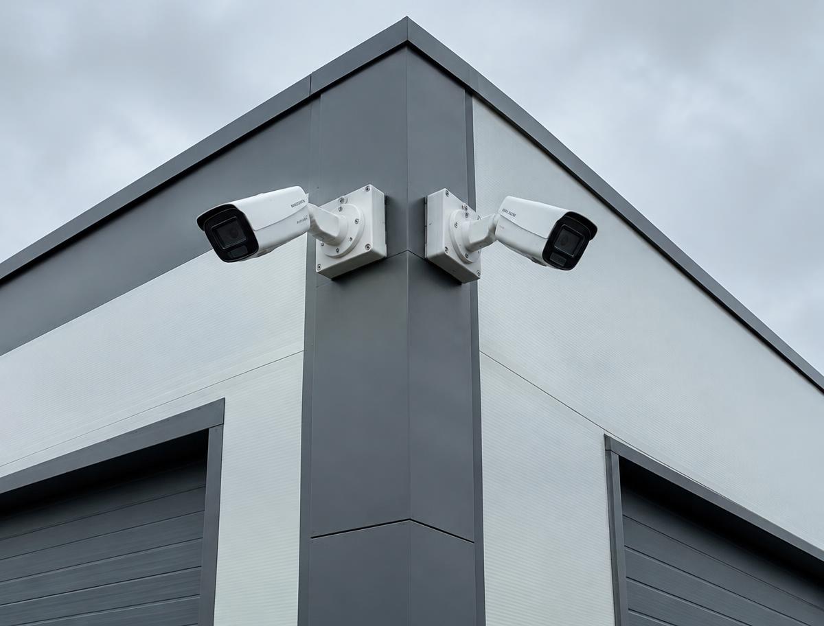 Two CCTV bullet cameras mounted on the corner of a commercial building