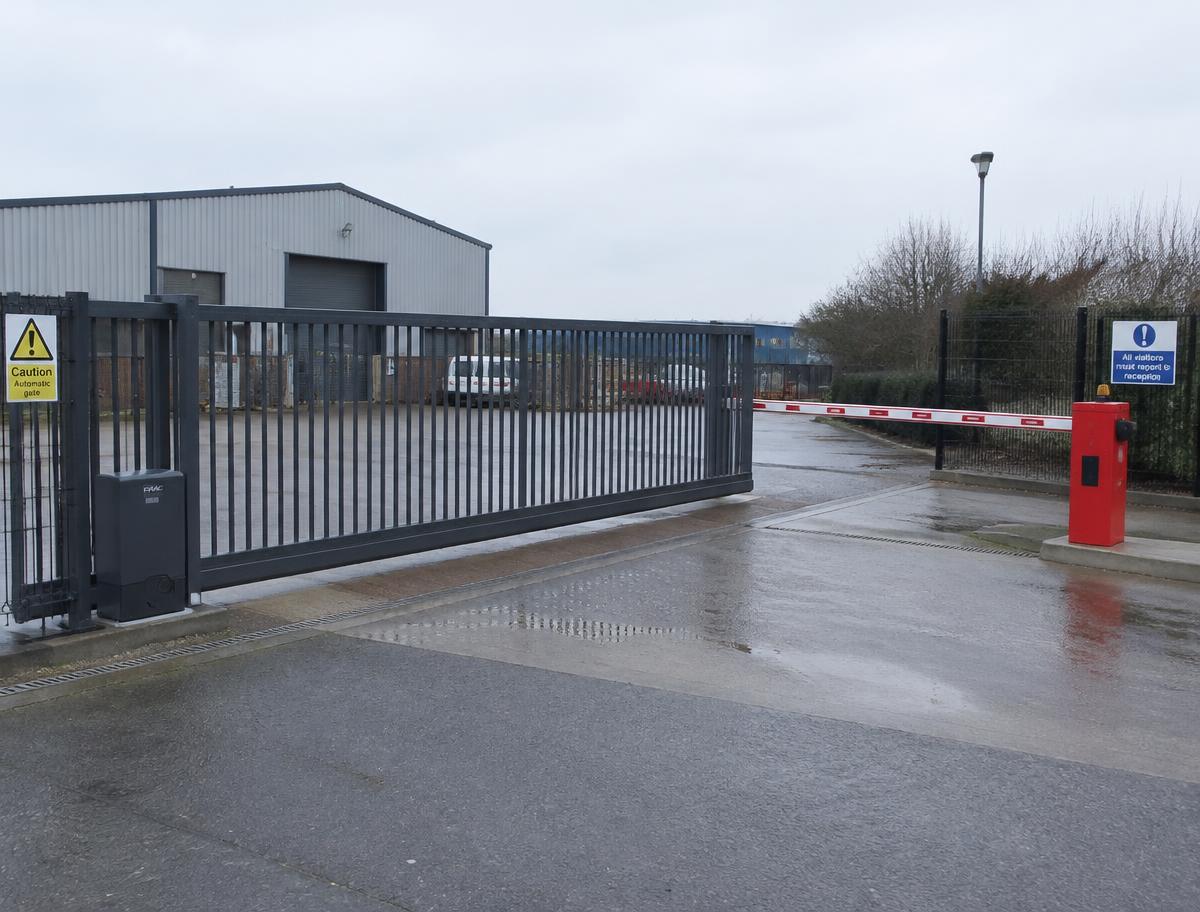 Automated sliding gate and vehicle barrier at an industrial yard entrance